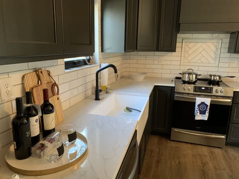 Well-equipped kitchen with farmhouse sink.