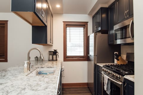 Fully equipped kitchen with pots, pans, and basic kitchen supplies. 