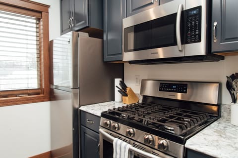 Fully equipped kitchen with pots, pans, and basic kitchen supplies. 