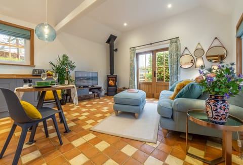 Ground floor: Open-plan sitting room with wood burning stove and french doors leading to the garden