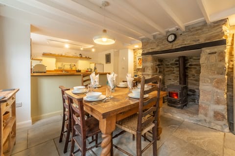 Ground floor: Dining area with table and a inglenook fireplace with wood burning stove