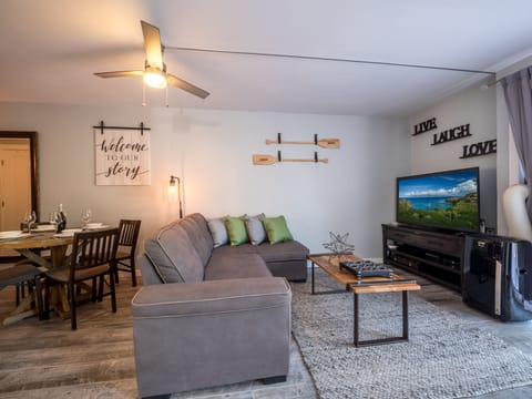 Cozy and modern living room featuring a queen-size sofa bed, 55" smart TV & A/C.