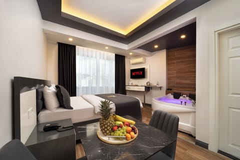 Deluxe Suite, 1 Queen Bed, Jetted Tub | In-room safe, individually decorated, individually furnished