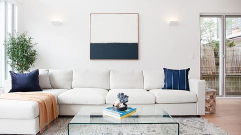 Floor-to-ceiling windows illuminate the spacious living room