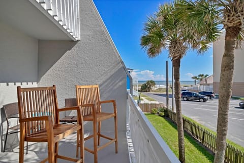 - Sip your morning coffee on this private balcony with ocean views and palm lined charm
- Tall seating makes it easy to enjoy the coastal breeze and scenery all day long
- Just steps from the sand with the beach visible from your front door