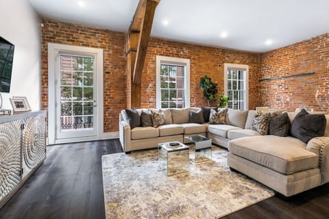 Open concept living, kitchen, and dining area with ample seating. Stream on 65” Samsung Smart 4K TV with DIRECTV. Relax on the large sectional and dine at a table for six with bar seating for four and plenty of natural light.