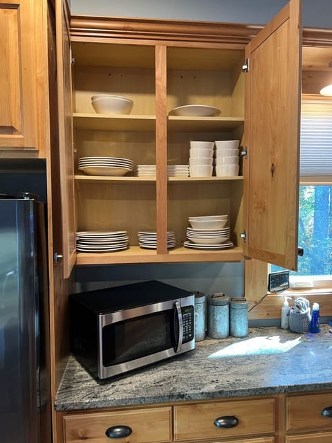 Fully stocked chefs kitchen and 10 person service dishes and silverware