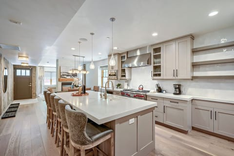 Your gourmet kitchen awaits with sleek white countertops, modern appliances, and a spacious island perfect for cooking and gathering with loved ones.