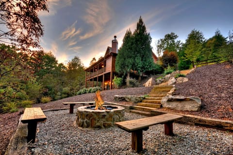 Outdoor landscape and professionally hardscaped with boulders and evergreens