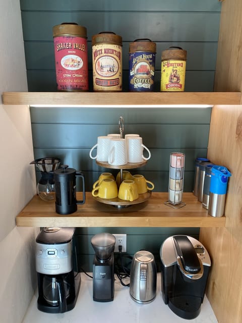 Coffee nook stocked with everything you need including a coffee grinder. 