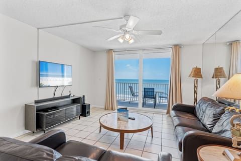 Relax in your spacious living room with stunning ocean views through floor-to-ceiling windows and step onto your private balcony.