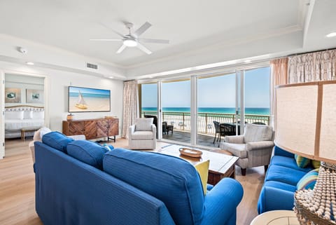 Bright coastal décor, plush seating, and a private balcony make relaxation effortless here.