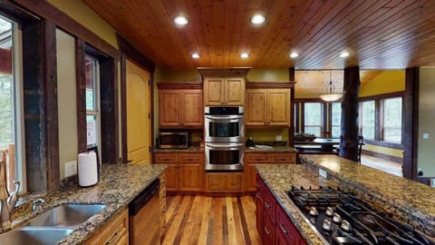 Full size open kitchen equipped with everything such as appliances, cookware, pots and pans, utensils, dishes, and basic cooking essentials.