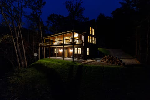 The back of the cabin and upper deck glowing in the night time air.