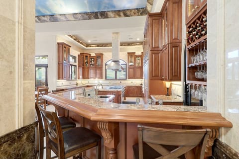 Gourmet kitchen with granite counters, wine bar & custom cabinets. Entertain!