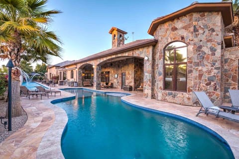 Luxury stone villa with private pool, hot tub, and arched patios.
