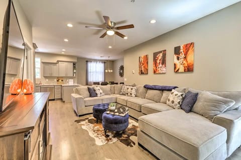 Living room with large sectional and cabinet electric fireplace