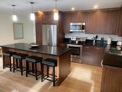 Modern kitchen with granite counter tops and stainless steel appliances.