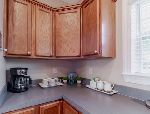 Coffee Bar . Upper cabinet with coffee, sugar, tea and several coffee mugs