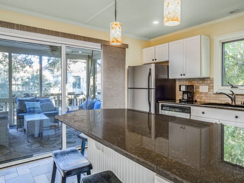 The kitchen has access to the screened porch