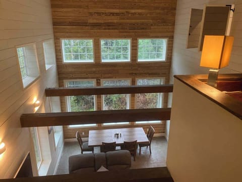 This a view from the 4th level, which is the game room looking down into the great room. The office is on the right and the entrance to the master bedroom and en-suite is just to the right of the desk. You can see the shutters on the right that open 