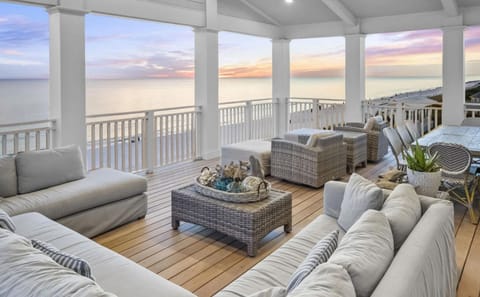 Expansive Oceanfront Terrace with Panoramic Gulf Views, Sunset Lighting, and Luxury Lounge Seating
