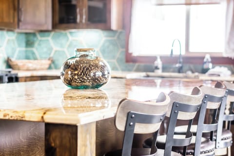 New kitchen including appliances, cabinets, ice maker, farmhouse sink, lighting.
