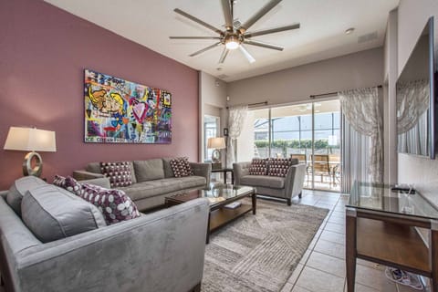 Living room with new ceiling fan and view of saltwater pool.