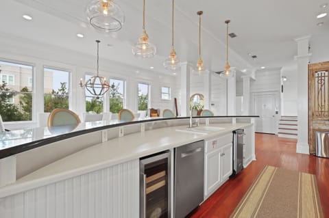 The island has a Eurocave, an ice maker, and a dishwasher available.