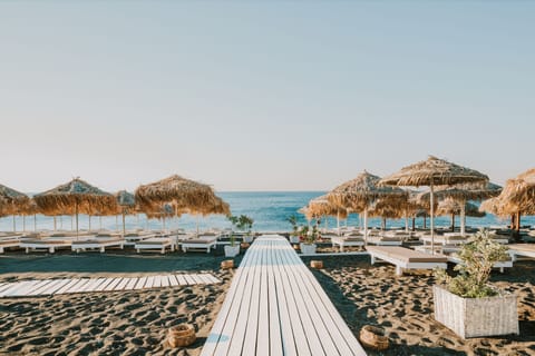 Private beach, black sand, sun loungers, beach umbrellas