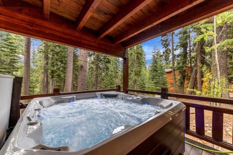 Our hot tub is on a covered deck with beautiful views of the forest.