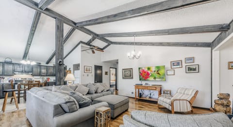 Main living room with high ceiling and flat screen TV