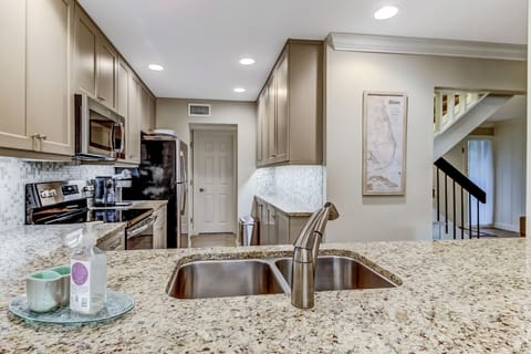 Fully Equipped Kitchen with Granite Countertops and Stainless Steel Appliances