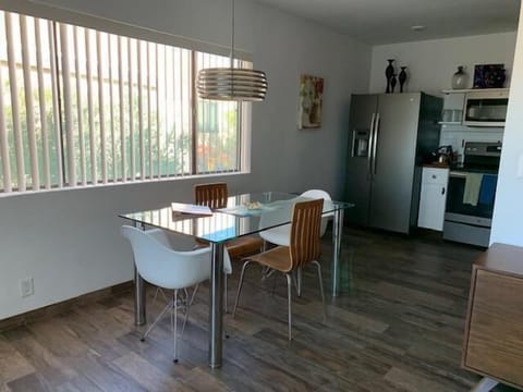 Large window in front of dining table.