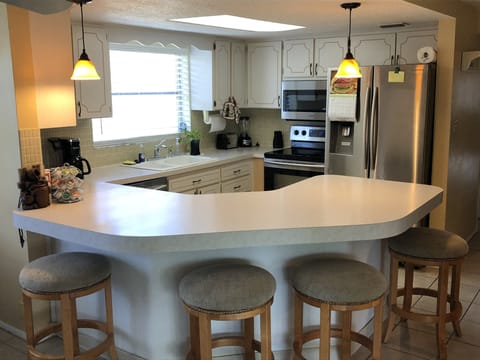 Full size Kitchen with stove, microwave, refrigerator, and dishwasher.