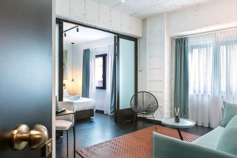 Deluxe Suite, City View | Hypo-allergenic bedding, in-room safe, soundproofing, iron/ironing board