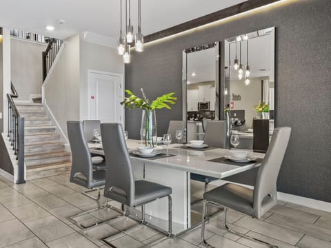 This luxurious eight seater dinner table with pool view from the outside