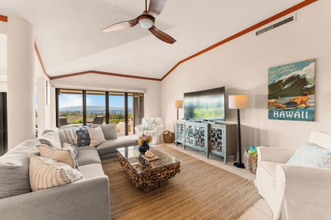 Family room - Spacious ocean-view living room with comfortable seating, smart TV, and natural light.