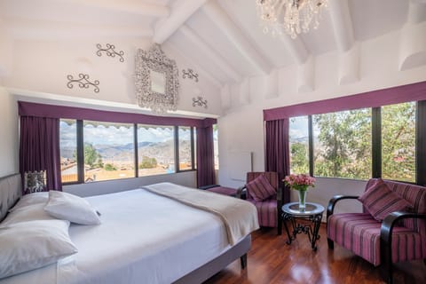 Deluxe Suite, City View | Down comforters, in-room safe, individually decorated, blackout drapes