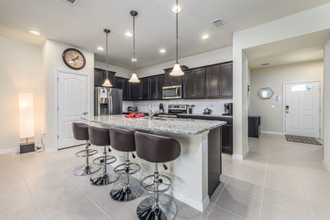 Beautiful modern style kitchen with pantry and barstool seating