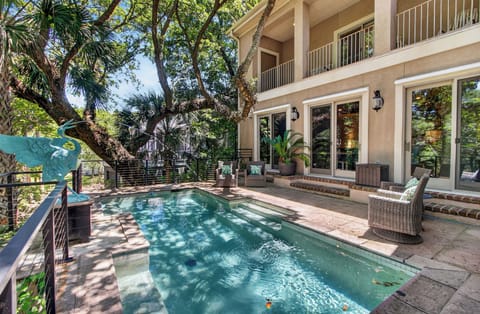 Slip into your private pool surrounded by lush tropical trees and shaded serenity. Relax on the patio with comfortable seating, just steps from your spacious balcony retreat.