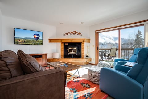 Cozy up in your mountain retreat with a crackling fireplace, stunning snow-capped views, and plush seating for perfect après-ski relaxation.