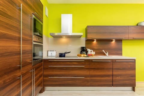 Kitchenette with oven and refrigerator.