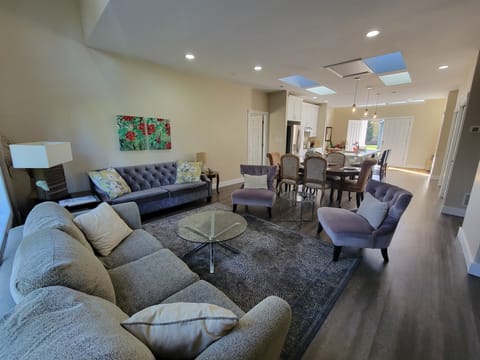 Main living room space in open floor plan with dining and kitchen area.