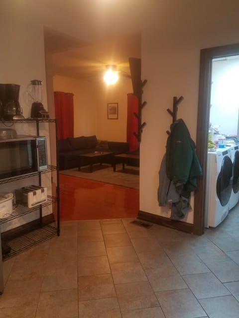Kitchen with coat rack and view of laundry area