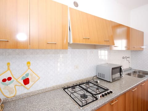 Countertop, Property, Room, Kitchen, Interior Design, Cabinetry, Yellow, House, Furniture, Tile