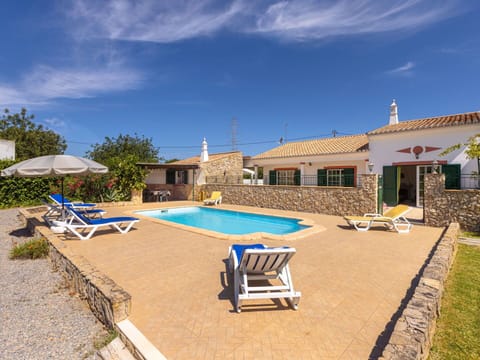 Sky, Cloud, Building, Property, Swimming Pool, Azure, House, Outdoor Furniture, Shade, Sunlounger