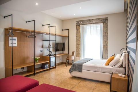 Deluxe Quadruple Room | Minibar, in-room safe, individually furnished, desk