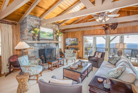 Main Living Area of Out On A Limb with Mountain Views, Stone Wood-Burning Fireplace, and HD Smart TV