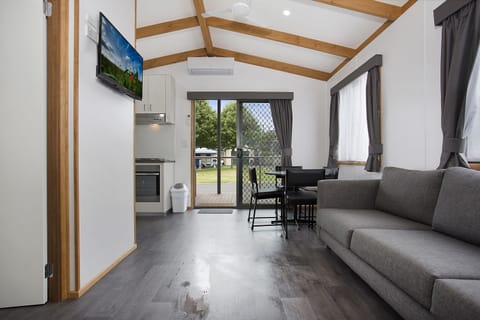 Deluxe Cabin, 2 Bedrooms | Living area | 32-inch LCD TV with digital channels, TV, DVD player